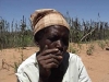 With her failed harvest in the background, this old lady dumped in rural Matabeleland in 2005 recounts the deaths of two children, and the burden of a daughter who has lapsed into mental illness: while barely surviving, she has no energy to move again. [May 2010]